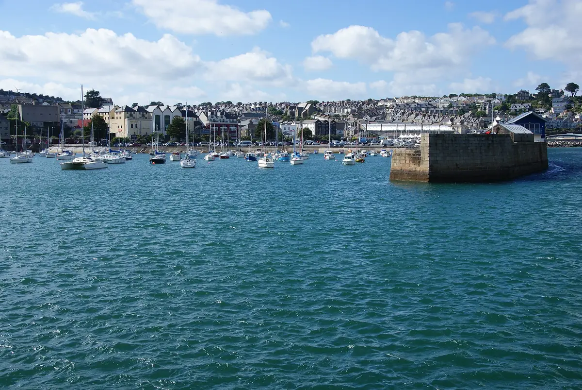 Boats in Penzance harbour with the town behind