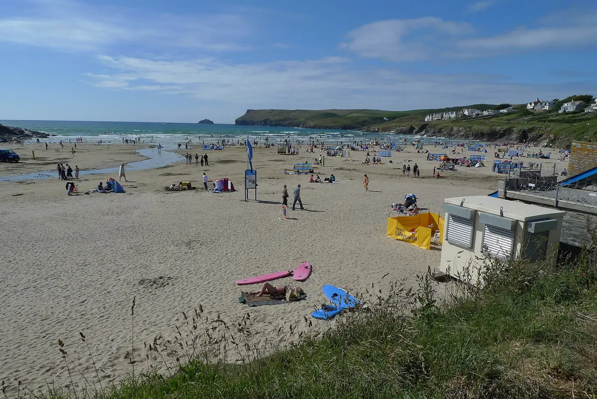 Families playing on the sand at Polzeath beach